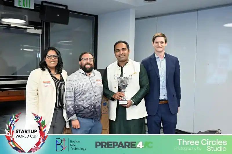 Akhil holding a trophy with three others at the Startup World Cup regional event.